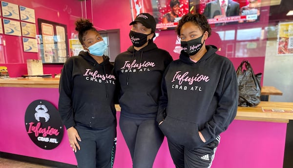 Infusion Crab ATL opened in September in Marietta and is owned and operated by Kimberly Knox (center) and her daughters McKenzie (left) and Madison. 
Wendell Brock for The Atlanta Journal-Constitution