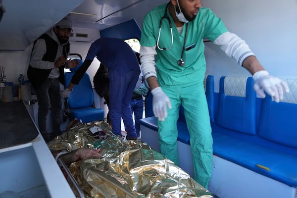 An injured United Nations Mine Action Service (UNMAS) worker is taken into the al-Aqsa Martyrs hospital after an explosion in Deir al-Balah in central Gaza, Wednesday March 19, 2025. (AP Photo/Abdel Kareem Hana)