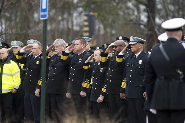 01/03/2019 — McDonough, Georgia — First responders salute the casket of slain Henry County Police Officer Michael Smith as his body is carried into Glen Haven Baptist Church in McDonough on Thursday. (ALYSSA POINTER/ALYSSA.POINTER@AJC.COM)