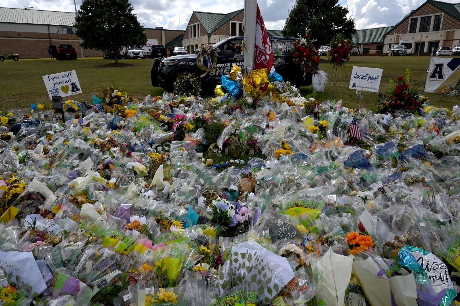 The memorial outside Winder's Apalachee High School, as seen on Thursday, is still growing.