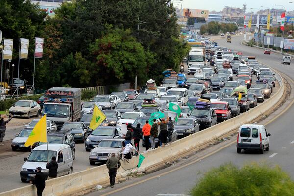 People sit in traffic as they return to their villages after a ceasefire between Israel and Hezbollah went into effect in Ghazieh, Lebanon, Wednesday, Nov. 27, 2024. (AP Photo/Mohammed Zaatari)