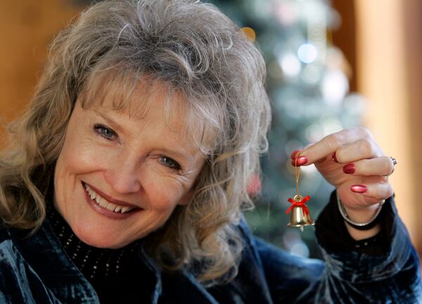 FILE - In this Dec. 8, 2006 file photo, Karolyn Grimes who played "Zuzu" in the movie "It's a Wonderful Life" poses for a photo in Seneca Falls, N.Y. For years, civic boosters have pointed out intriguing parallels that suggest Seneca Falls was the inspiration for Bedford Falls, the make-believe mill town in "It's a Wonderful Life." (AP Photo/David Duprey, File)