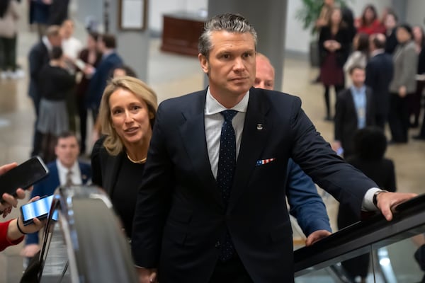 Pete Hegseth, President-elect Donald Trump's nominee to be defense secretary, is joined by his wife Jennifer Rauchet, as they walk through the basement of the Capitol, Wednesday, Dec. 4, 2024, in Washington. (AP Photo/Mark Schiefelbein)