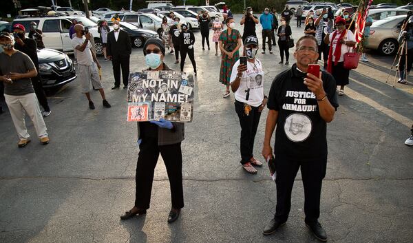 People gather in the parking lot of the Victory Outreach Church in Atlanta for a quick rally before driving down to Brunswick Saturday, May 16, 2020. STEVE SCHAEFER FOR THE ATLANTA JOURNAL-CONSTITUTION