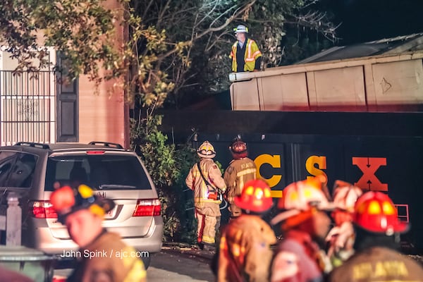 A man was injured when a train derailed and crashed into a house in northwest Atlanta early Thursday. JOHN SPINK / JSPINK@AJC.COM