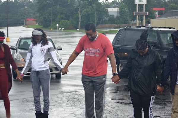 Mike Weaver (center) prays with volunteers before departing for a service tour in Miami earlier this year. CONTRIBUTED