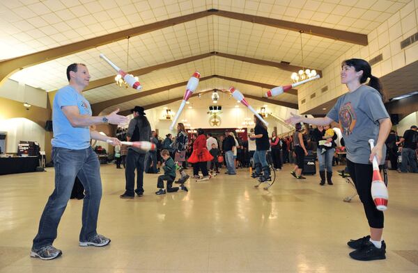 In this file photo from 2014, Neil Jordaan (left) and Heather Marriott practice “passing pins” during the annual Groundhog Day Jugglers Festival at the Yaarab Shrine Center in Atlanta. This year’s event will be held Feb. 2-4. HYOSUB SHIN / HSHIN@AJC.COM