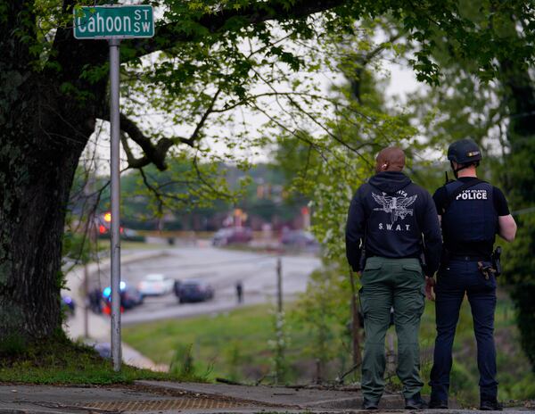 SWAT officers look over the scene Friday morning.