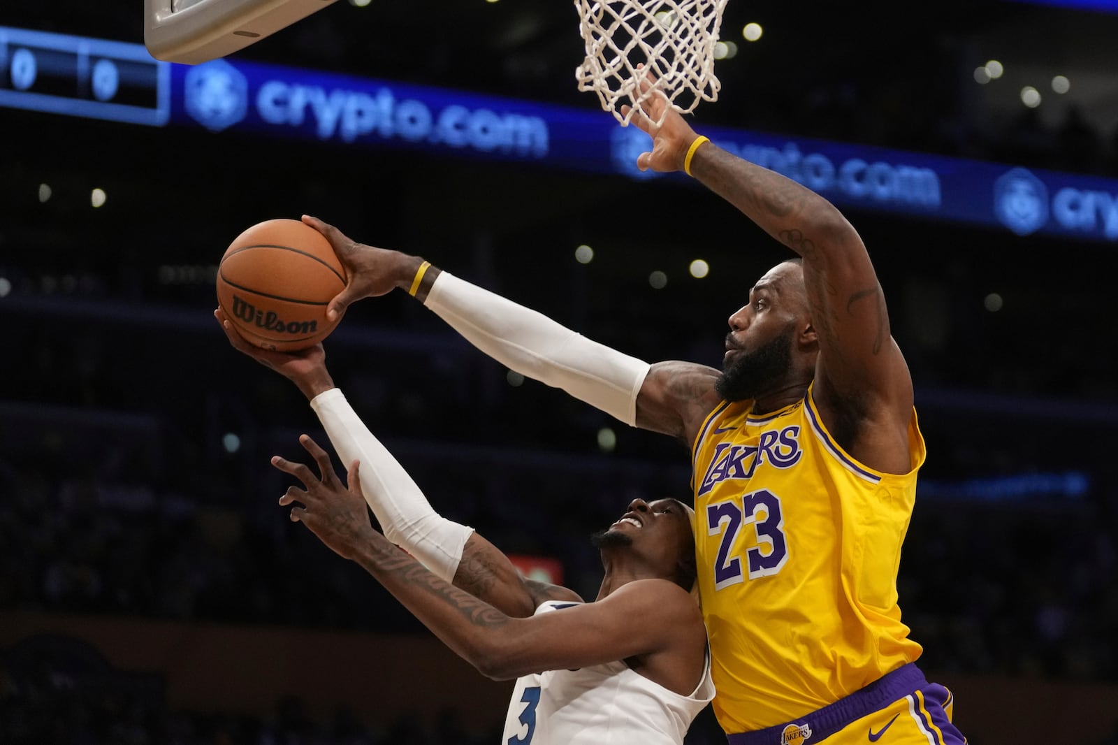 Los Angeles Lakers forward LeBron James (23) blocks a shot attempt by Minnesota Timberwolves forward Jaden McDaniels (3) during the first half of an NBA basketball game, Tuesday, Oct. 22, 2024, in Los Angeles. (AP Photo/Eric Thayer)