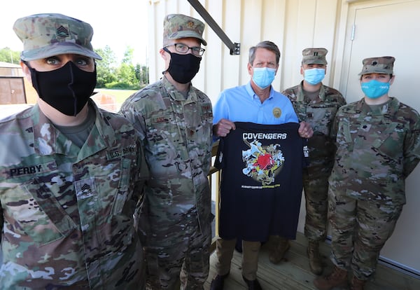 050520 Albany: Members of the Georgia Army National Guard and Georgia Air National Guard present Gov. Brian Kemp with a Covengers Albany COVID-19 Response Team shirt while he tours the temporary medical pod that has been placed at the Phoebe North Campus of Phoebe Putney Health System on Tuesday, May 5, 2020, in Albany. The pod at Phoebe North arrived on April 15 and is scheduled to begin operations on Wednesday, May 6, housing 24 beds to treat non-critical COVID-19 patients.  Curtis Compton ccompton@ajc.com