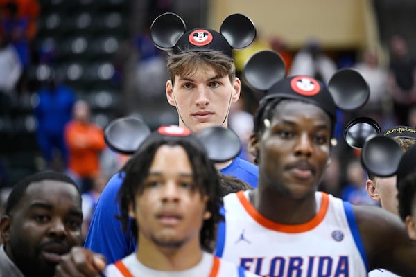 FILE - Florida center Olivier Rioux, rear, stands behind teammates during the trophy presentation after their win against Wichita State in an NCAA college basketball game at the ESPN Events Invitational tournament, Friday, Nov. 29, 2024, in Kissimmee, Fla. (AP Photo/Phelan M. Ebenhack, File)