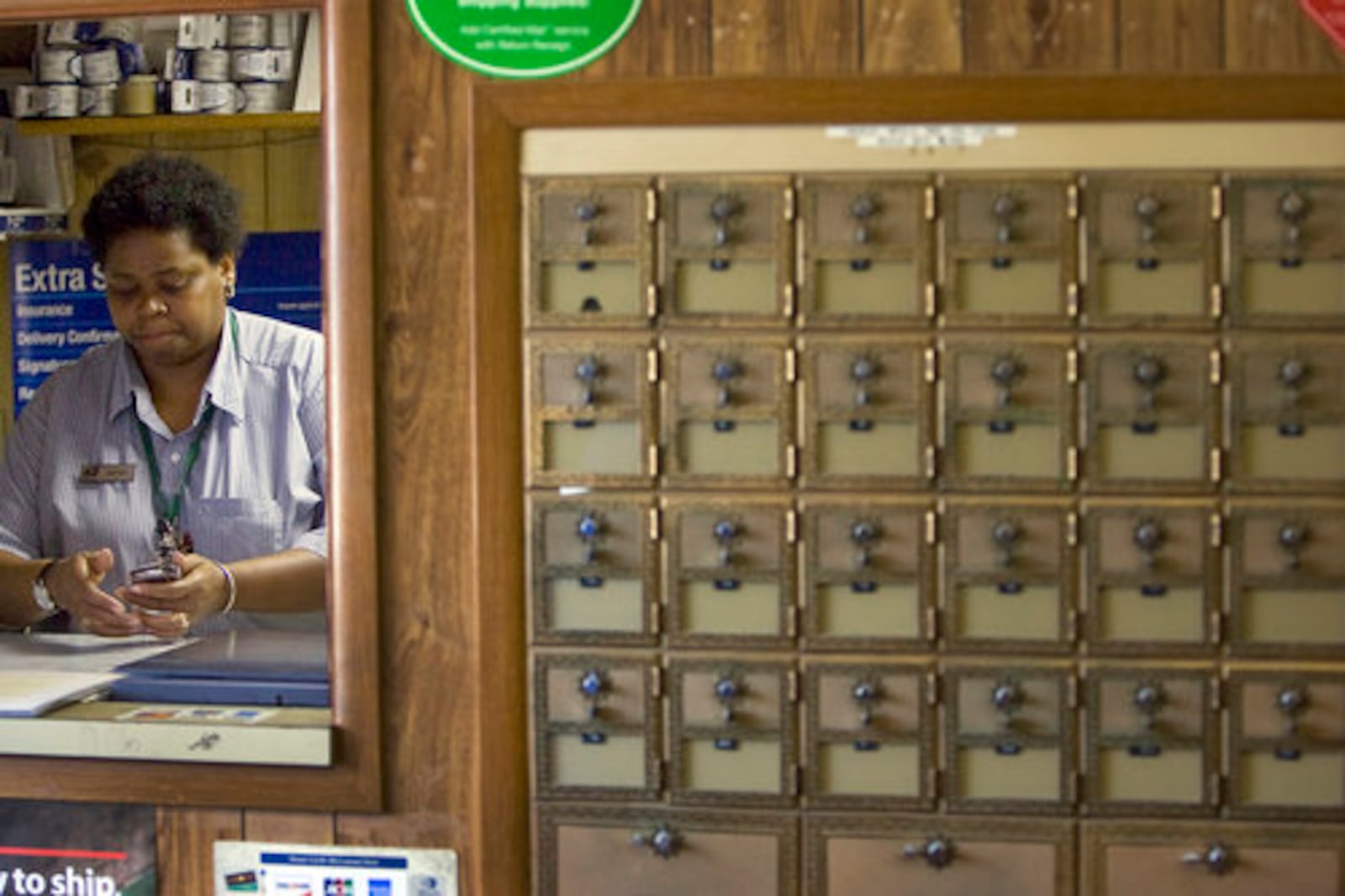 Postmaster Joyce Macfoy readies to close her office promptly at 3:30p each weekday.