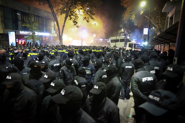 Police gather to push protesters away from a street during a rally against the results of the parliamentary elections amid allegations that the vote was rigged in Tbilisi, Georgia, on Tuesday, Nov. 19, 2024. (AP Photo/Zurab Tsertsvadze)