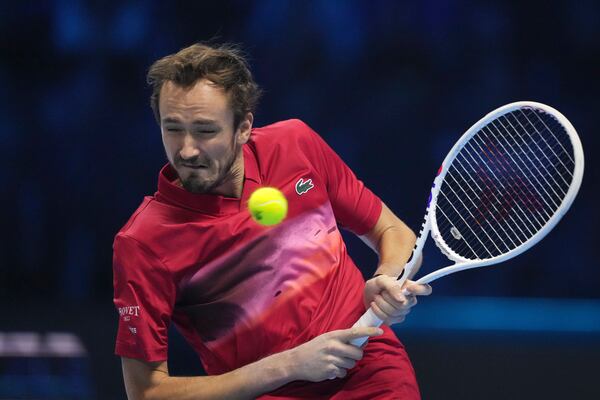 Russia's Daniil Medvedev returns the ball to Australia's Alex de Minaur during their singles tennis match of the ATP World Tour Finals at the Inalpi Arena, in Turin, Italy, Tuesday, Nov. 12, 2024. (AP Photo/Antonio Calanni)