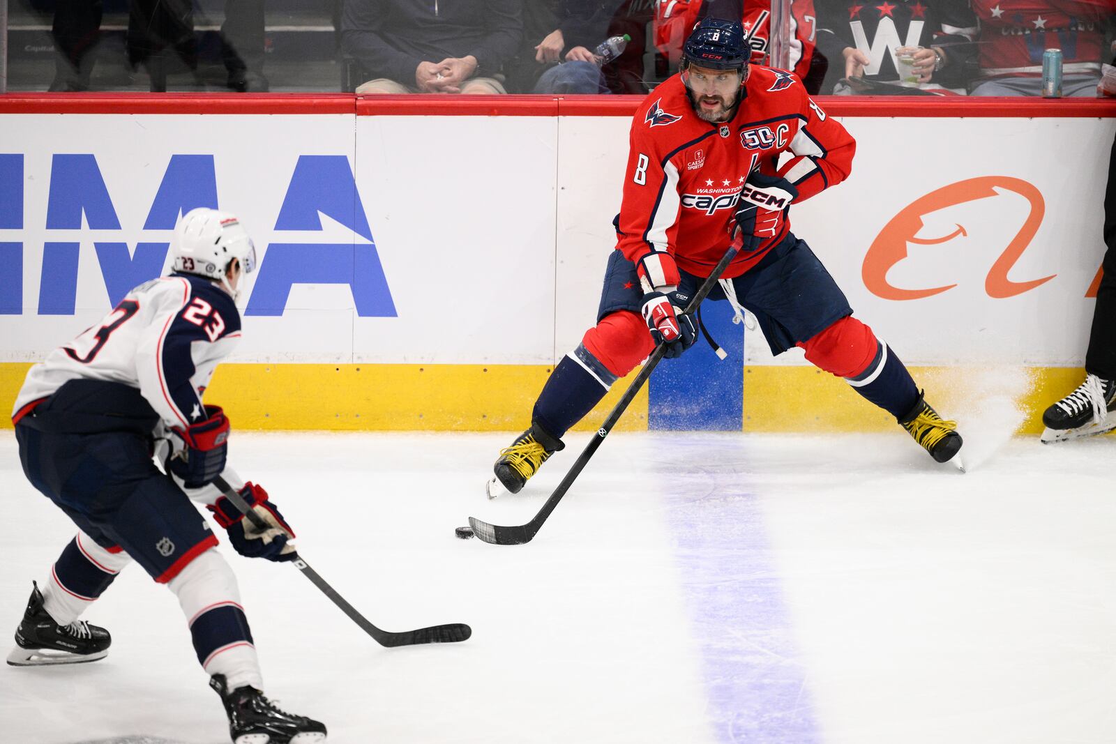 Washington Capitals left wing Alex Ovechkin (8) skates with the puck against Columbus Blue Jackets center Sean Monahan (23) during the third period of an NHL hockey game, Saturday, Nov. 2, 2024, in Washington. The Capitals won 7-2. (AP Photo/Nick Wass)