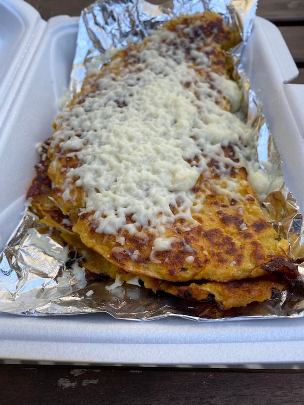 Numerous Arepa Grill menu items, including a corn pancake known as a cachapa (pictured), feature queso de mano, a soft white cheese frequently used in Venezuelan cooking. Ligaya Figueras/ligaya.figueras@ajc.com
