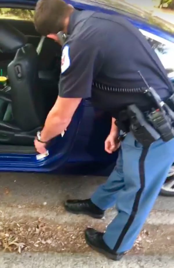 A Cobb County police officer asking two children to get out of the car. He was called by a woman who thought it odd that a black man was with white kids. 