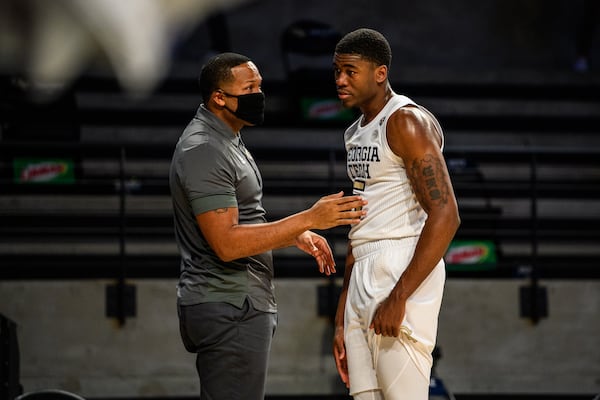 Georgia Tech assistant coach Anthony Wilkins (left) confers with Yellow Jackets player Moses Wright during the team's win over Florida A&M on Dec. 18, 2020 at McCamish Pavilion. (Danny Karnik/Georgia Tech Athletics)