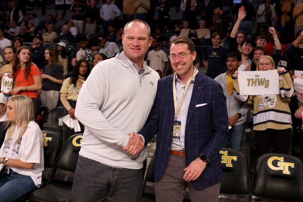 Georgia Tech Yellow Jackets football head coach Brent Key greets Tech’s Athletic Director J Batt after Key addressed fans during halftime of Tech’s game against the Georgia Bulldogs at McCamish Pavilion, Tuesday, December 6, 2022, in Atlanta. (Jason Getz / Jason.Getz@ajc.com)