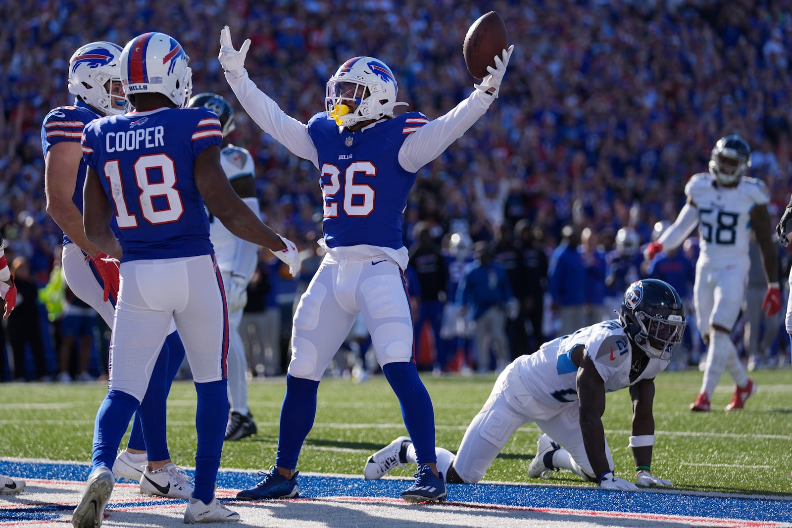 Buffalo Bills running back Ty Johnson (26) celebrates a touchdown against the Tennessee Titans with teammates during the second half of an NFL football game Sunday, Oct. 20, 2024, in Orchard Park, N.Y. (AP Photo/Charles Krupa)