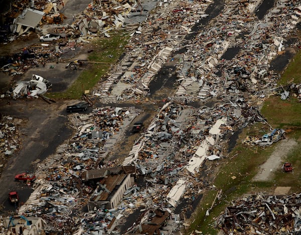 FILE- In this May 24, 2011 file photo, a destroyed neighborhood is seen in Joplin, Mo. (AP Photo/Charlie Riedel, File)