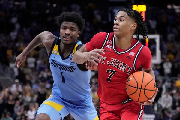 St. John's's Simeon Wilcher gets past Marquette's Kam Jones during the second half of an NCAA college basketball game Saturday, March 8, 2025, in Milwaukee. (AP Photo/Morry Gash)