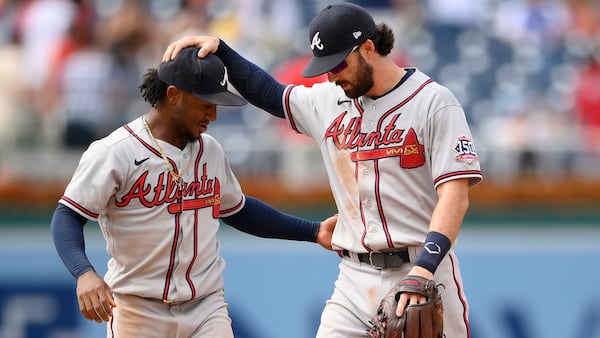 Braves second baseman Ozzie Albies (left) and shortstop Dansby Swanson celebrate 6-5 win over the Washington Nationals, Sunday, Aug. 15, 2021, in Washington. (Nick Wass/AP)