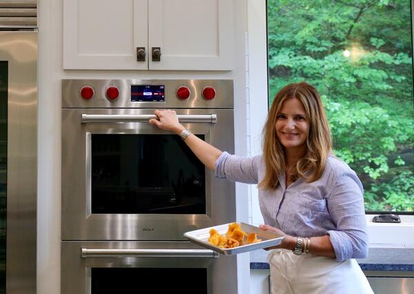 Dana Nahai, who teaches cooking with foraged ingredients at her farm, the Barn at Stillhouse Creek in Ellijay, puts some newly foraged chanterelle mushrooms into the oven to dry them for storage. 
(Courtesy of Dana Nahai)