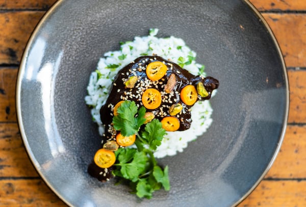 Banshee’s braised duck leg is beautifully plated to show off the meat’s dark mahogany sheen. CONTRIBUTED BY HENRI HOLLIS