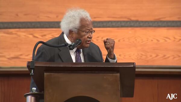 The Rev. James M. Lawson Jr., shown paying tribute to Rep. John Lewis, marks death days in his calendar for people such as C.T. Vivian and Lewis. (AJC file photo)