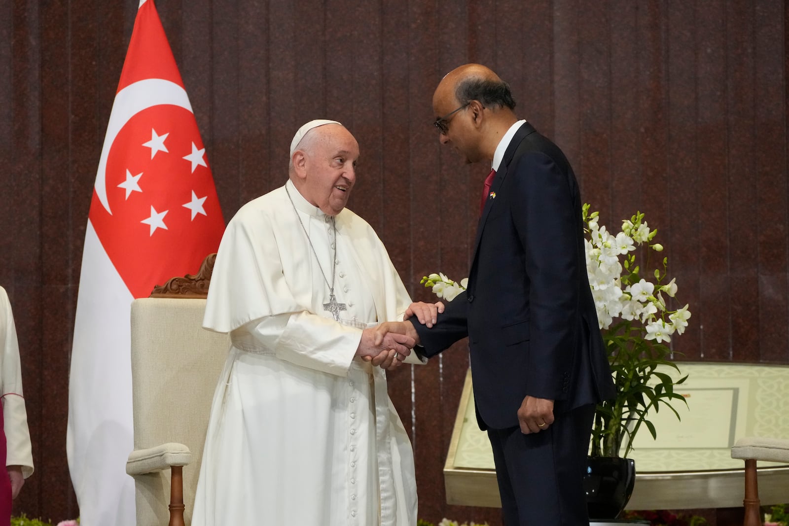 Pope Francis is greeted by the President of the Singapore Republic Tharman Shanmugaratnam, right, during a welcome ceremony at the Parliament House in Singapore, Thursday, Sept. 12, 2024. Pope Francis flew to Singapore on Wednesday for the final leg of his trip through Asia, arriving in one of the world's richest countries from one of its poorest after a record-setting final Mass in East Timor. (AP Photo/Gregorio Borgia)