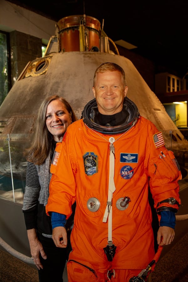 Portrait of Debi Huffman with a life sized pictures of Astronaut Eric Boe at the Fernbank Science Center in Decatur. Georgia Tech graduate Eric Boe is going back to space. Boe and Huffman have kept in touch and remained close over the years. (Photo by Phil Skinner)