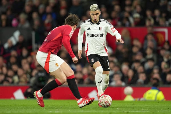 Fulham's Andreas Pereira, right, challenges for the ball with Manchester United's Matthijs de Ligt during the English FA Cup soccer match between Manchester United and Fulham at the Old Trafford stadium in Manchester, England, Sunday, March 2, 2025. (AP Photo/Jon Super)