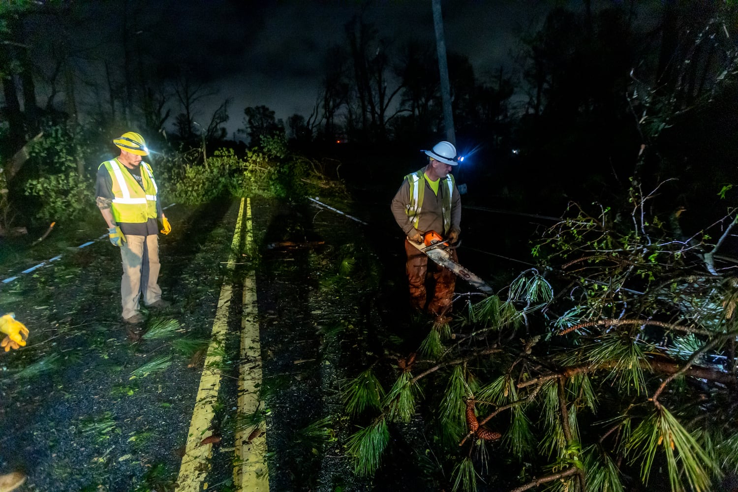 Power crews were hard at at work on McDaniel Mill Road early Wednesday morning, April 3, 2024, dealing with severe storm damage in Rockdale County. (John Spink / John.Spink@ajc.com)