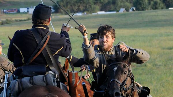 Union and Confederate cavalry members clash during a re-enactment at Nash Farm Battlefield in 2014. KENT D. JOHNSON / KDJOHNSON@AJC.COM