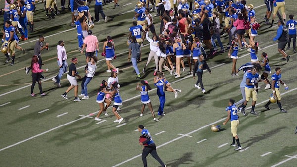 McEachern fans and players storm the field after Friday's win over Hillgrove. (Daniel Varnado/Special)