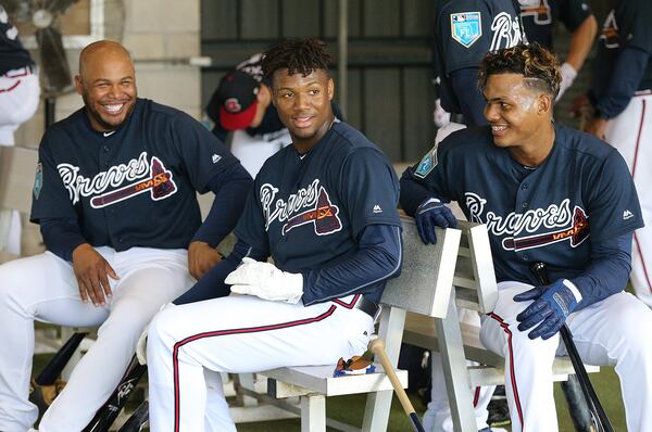 Yes, there is work to be done but that doesn't mean former Braves outfielder Andruw Jones (from left) and outfielders Ronald Acuna and Cristian Pache can't yuk it up in the batting cages. (Curtis Compton/ccompton@ajc.com)