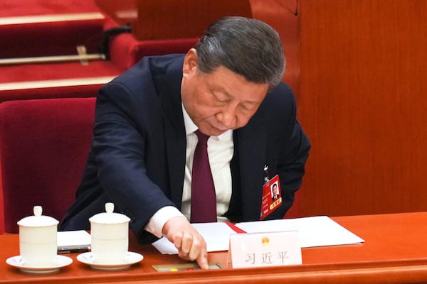 Chinese President Xi Jinping presses a button to vote during the closing ceremony of the National People's Congress held at the Great Hall of the People in Beijing, Tuesday, March 11, 2025. (AP Photo/Ng Han Guan)