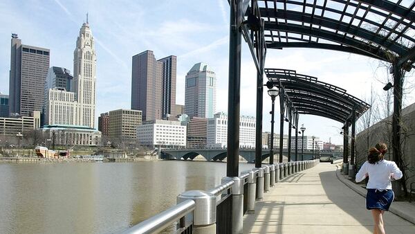 FILE PHOTO: A woman runs the Franklinton floodwall next to the Scioto River in Columbus, Ohio. The largest city named for Christopher Columbus has called off its observance of the holiday named for the explorer. Offices in Columbus, Ohio, will remain open Monday, Oct. 8, 2018, and close on Veterans Day instead.