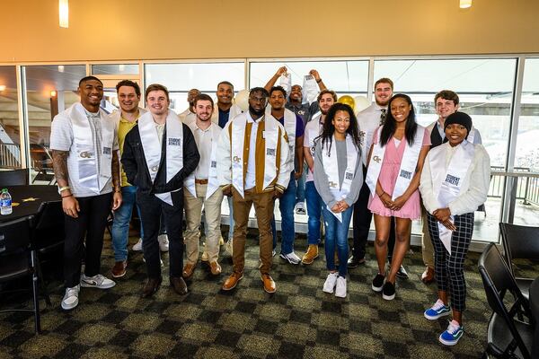 Some of the 23 Georgia Tech athletes who were to graduate Dec. 17-18, 2021 gathered at Bobby Dodd Stadium to celebrate their degrees. (Georgia Tech Athletics)