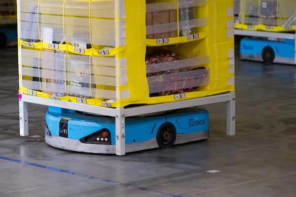 Small, blue robots lift pods of merchandise from below and move them around Amazon’s robotic fulfillment center in Stone Mountain on Wednesday, Oct. 23, 2024. (Ben Gray for the AJC)