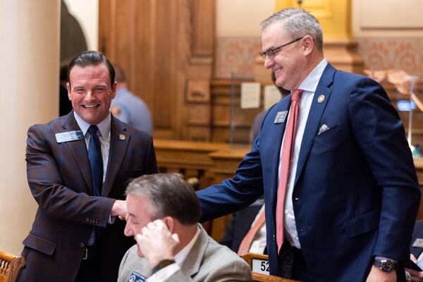 State Sen. Shawn Still (right) shakes hands with State Sen. Clint Dixon during the General Assembly session earlier this year.