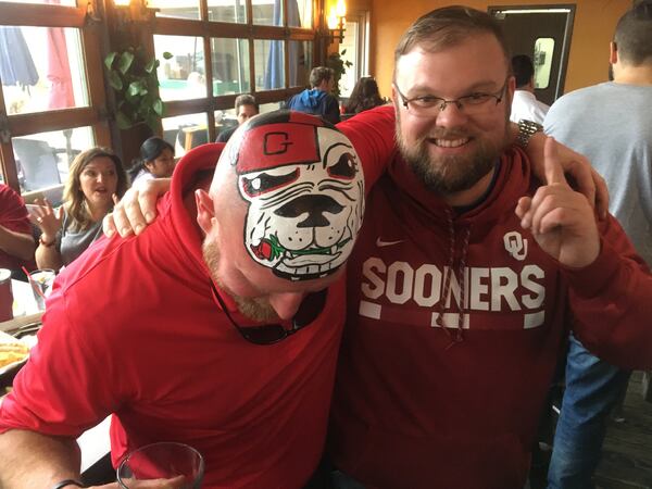  Robert King is an Oklahoma fan but wanted a photo with UGA superfan Trent "Big Dawg III" Woods. Photo: Jennifer Brett