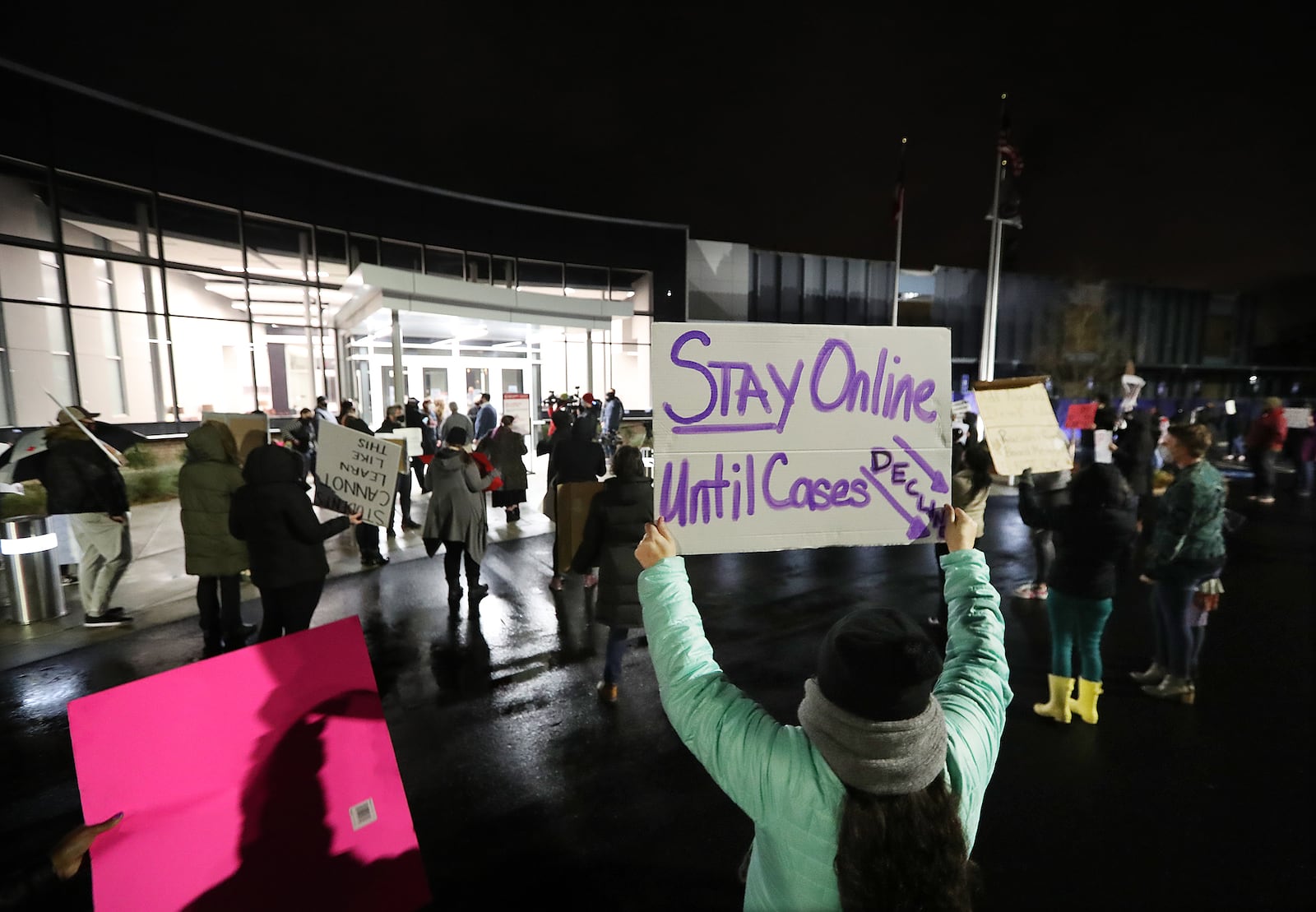 Hundreds of Cobb County teachers and staff hold a protest in the parking lot during the school board meeting at the Cobb County School District's Offices on Thursday in Marietta.  Curtis Compton / Curtis.Compton@ajc.com”