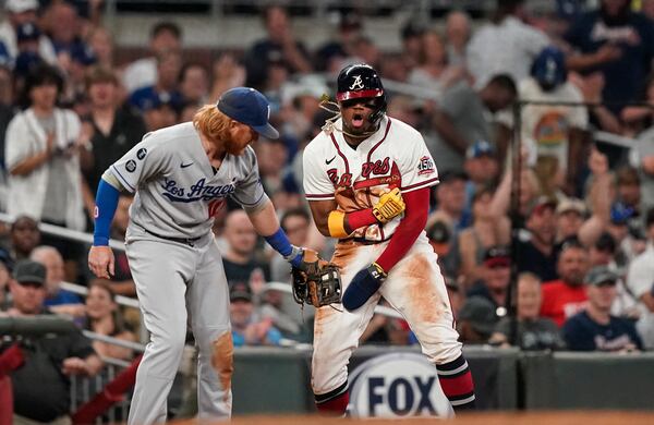 Braves outfielder Ronald Acuna (right) reacts after sliding safely into third against Los Angeles Dodgers third baseman Justin Turner (10) in the seventh inning Saturday, June 5, 2021, in Atlanta. (Brynn Anderson/AP)