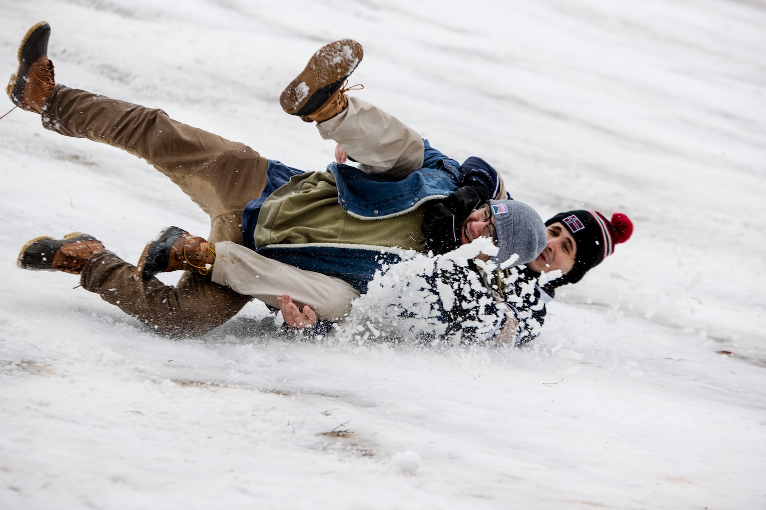 Atlanta residents crash their sled at Piedmont Park in Midtown Atlanta on Friday, January 10, 2025. Two inches of snow fell on the Midtown area and Atlanta residents took advantage of it by sledding, throwing snowballs and building snowmen. CHRISTINA MATACOTTA FOR THE ATLANTA JOURNAL-CONSTITUTION.  