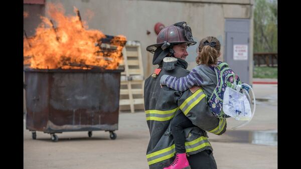 Olivia Gant prepares to help put out a fire in an April 2017 photo. The girl's mother, Kelly Turner, is accused of murder, fraud and other charges in her Aug. 20, 2017, death. Authorities say Turner, 41, lied about her daughter being terminally ill.