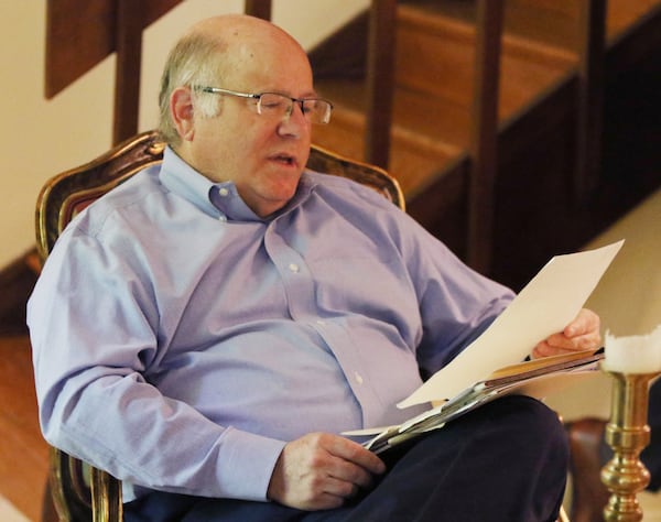 Stephen Phillips looks over documents while talking about his opposition to the expansion of Holy Spirit Catholic Church and its associated preparatory school in Sandy Springs, Georgia on Monday, April 29, 2019. (EMILY HANEY/emily.haney@ajc.com)