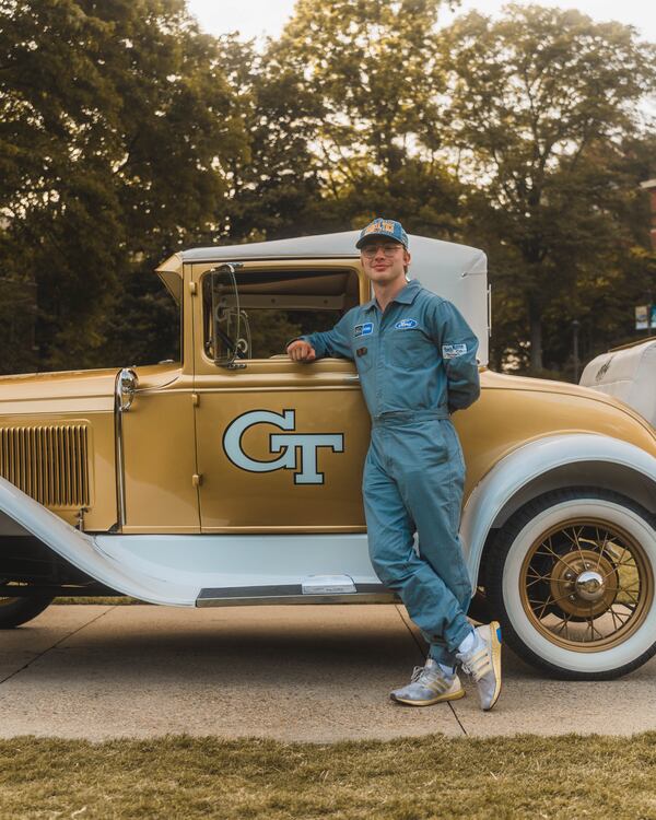 Georgia Tech student Matthew Kistner poses with the Ramblin' Wreck. Kistner, from Florence, South Carolina, is serving as the car's driver for 2024. (Chase Goulet)