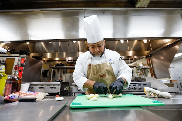 Chef Antonio Nazario prepares a banana dish at Lenbrook retirement community.
(Miguel Martinez / AJC)